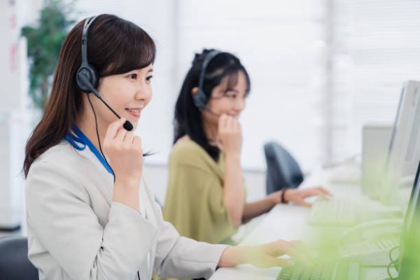 A woman responding to a customer at a call center