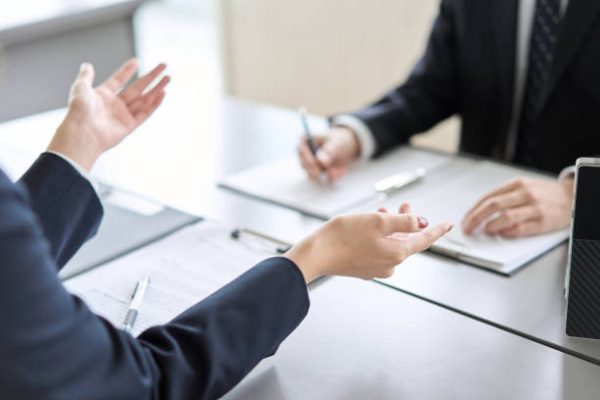 Hand of a business woman giving an explanation at a meeting